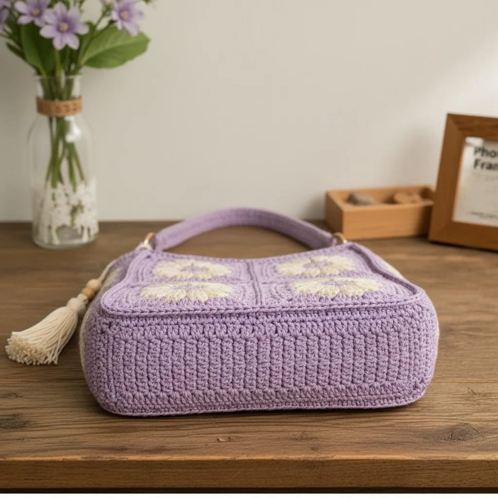 Crochet daisy bag women in lavender with floral granny square design and tassel, perfect boho accessory.